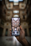 shallow focus photography unknown person holding black smartphone