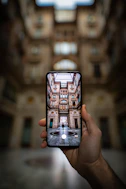 shallow focus photography unknown person holding black smartphone