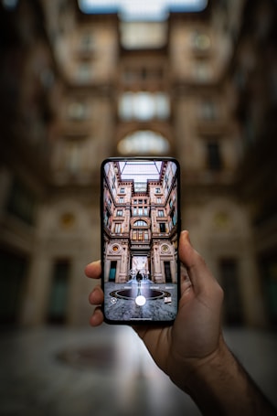 shallow focus photography unknown person holding black smartphone