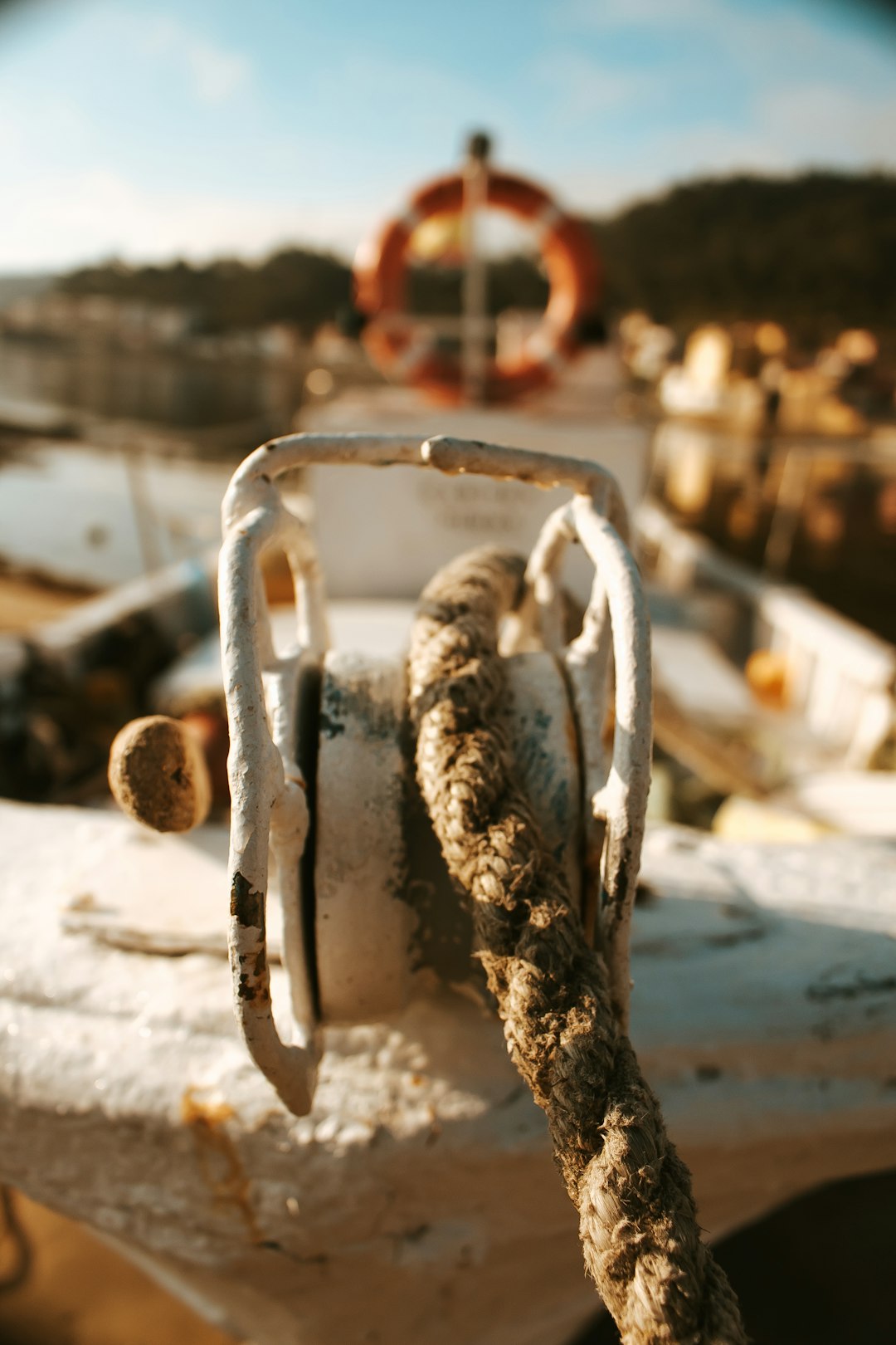 brown rope on white metal pulley