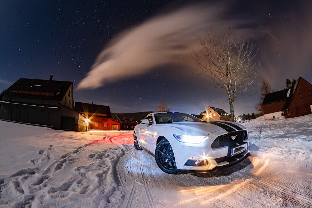 white Ford Mustang beside bare tree