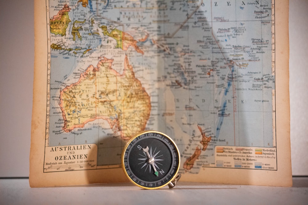 round gold and black compass and map chart