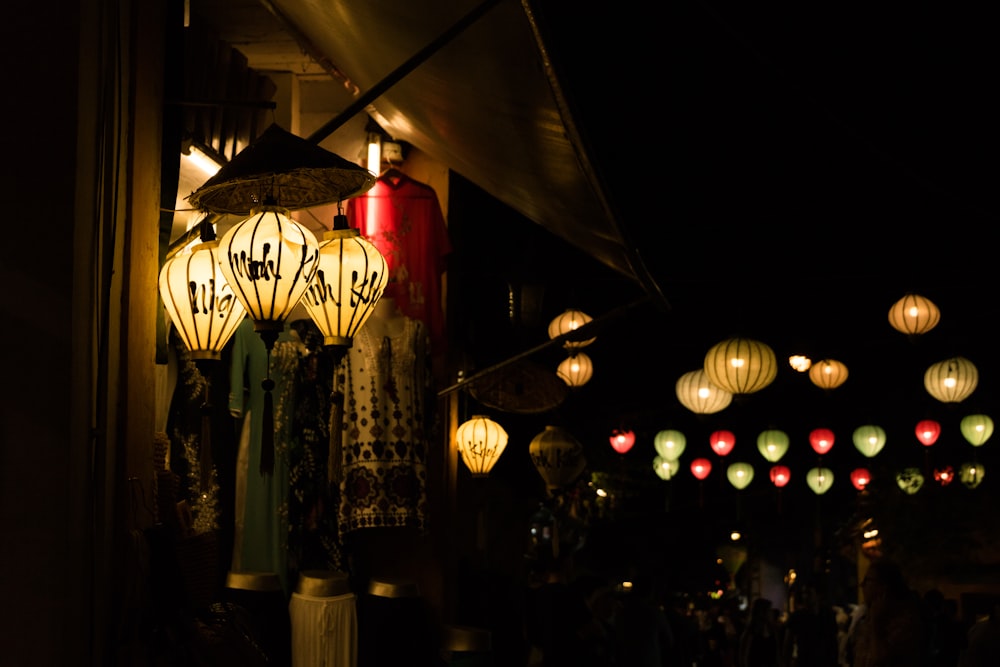 turned-on lanterns hanging outside a house during nighttime