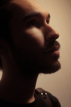 Juan Baraza in contemplative pose against a deep gray background.