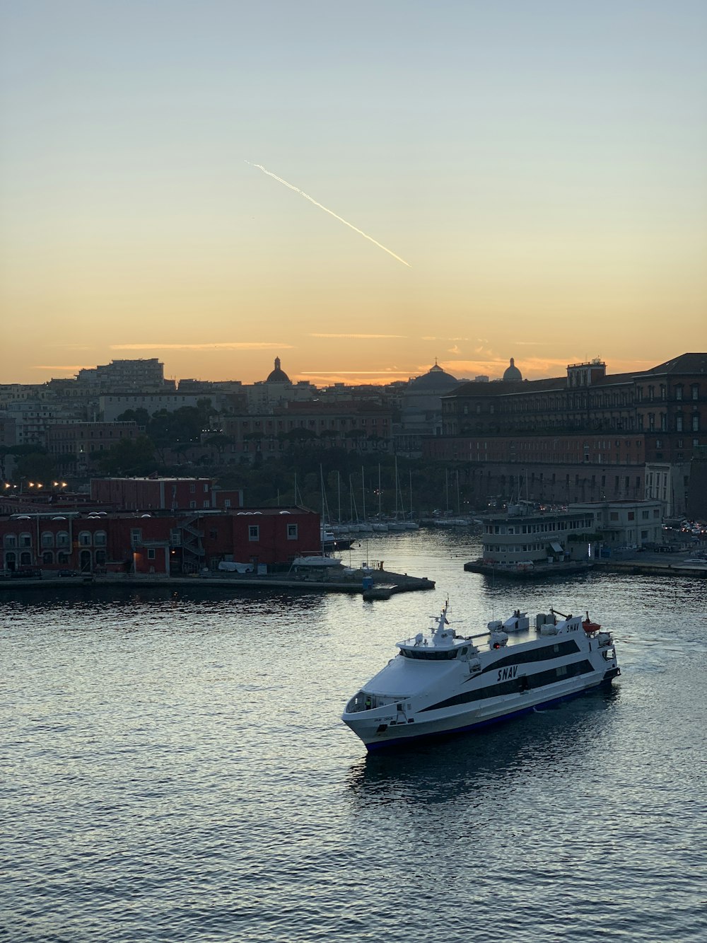 white ship floating on a body of water