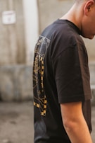 A model wearing a black t-shirt with an eye-catching design.