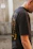 Photo of a person wearing a black oversized t-shirt from Bad Mood Collection with the Zet56 character prominently displayed.