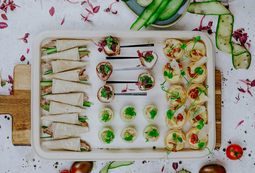 a tray of food on a wooden cutting board