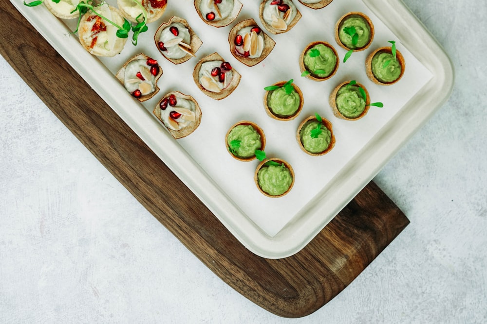 a platter of appetizers with guacamole on them