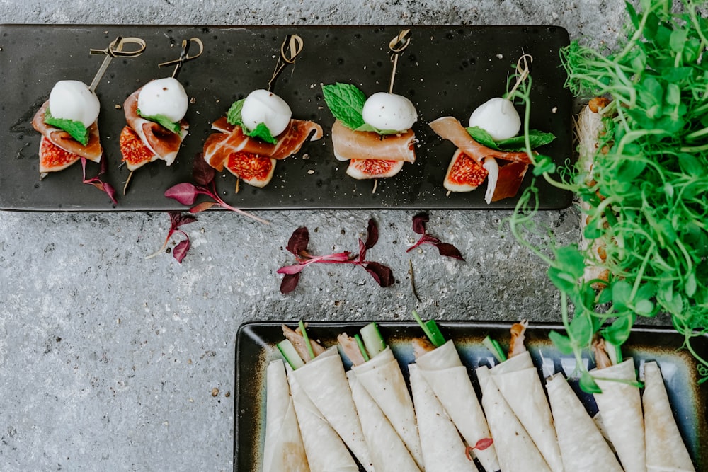 a plate of appetizers with meat and vegetables