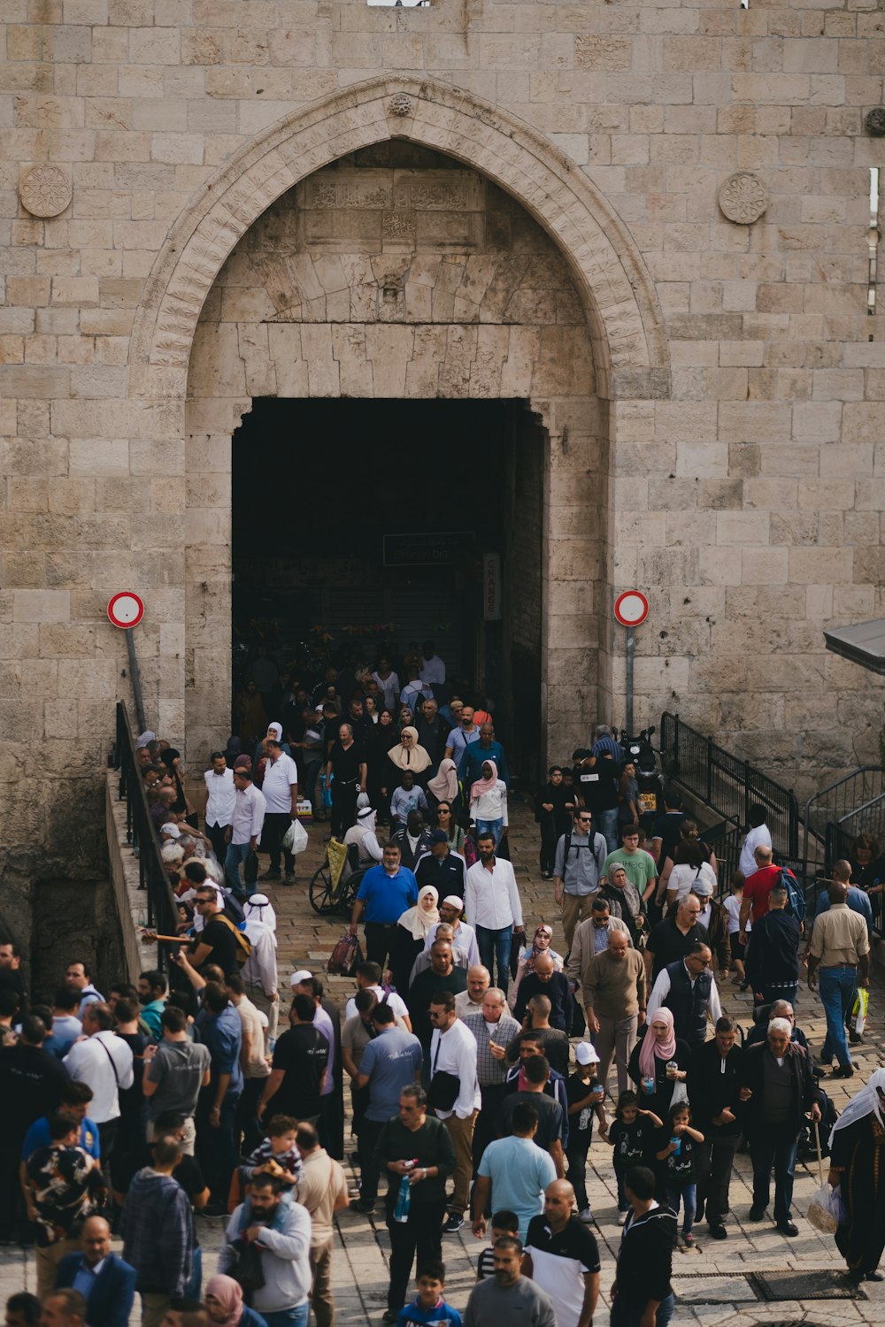 crowd of people standing and others are walking on street