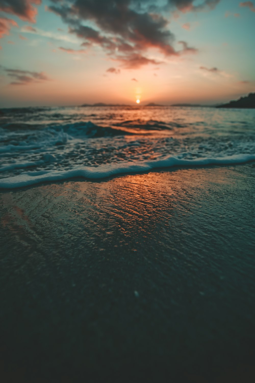 sea on shore during golden hour