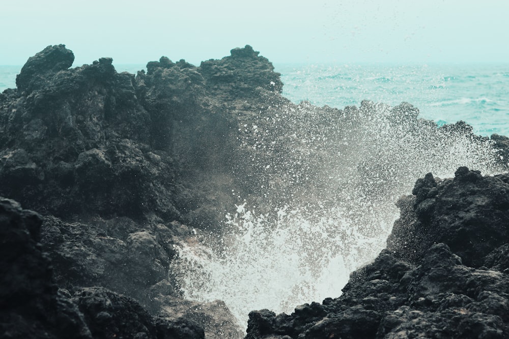 sea waves on gray rock formations