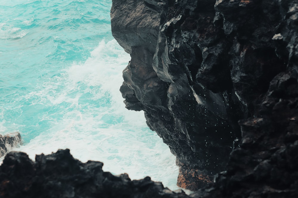 aerial photography of body of water and cliff