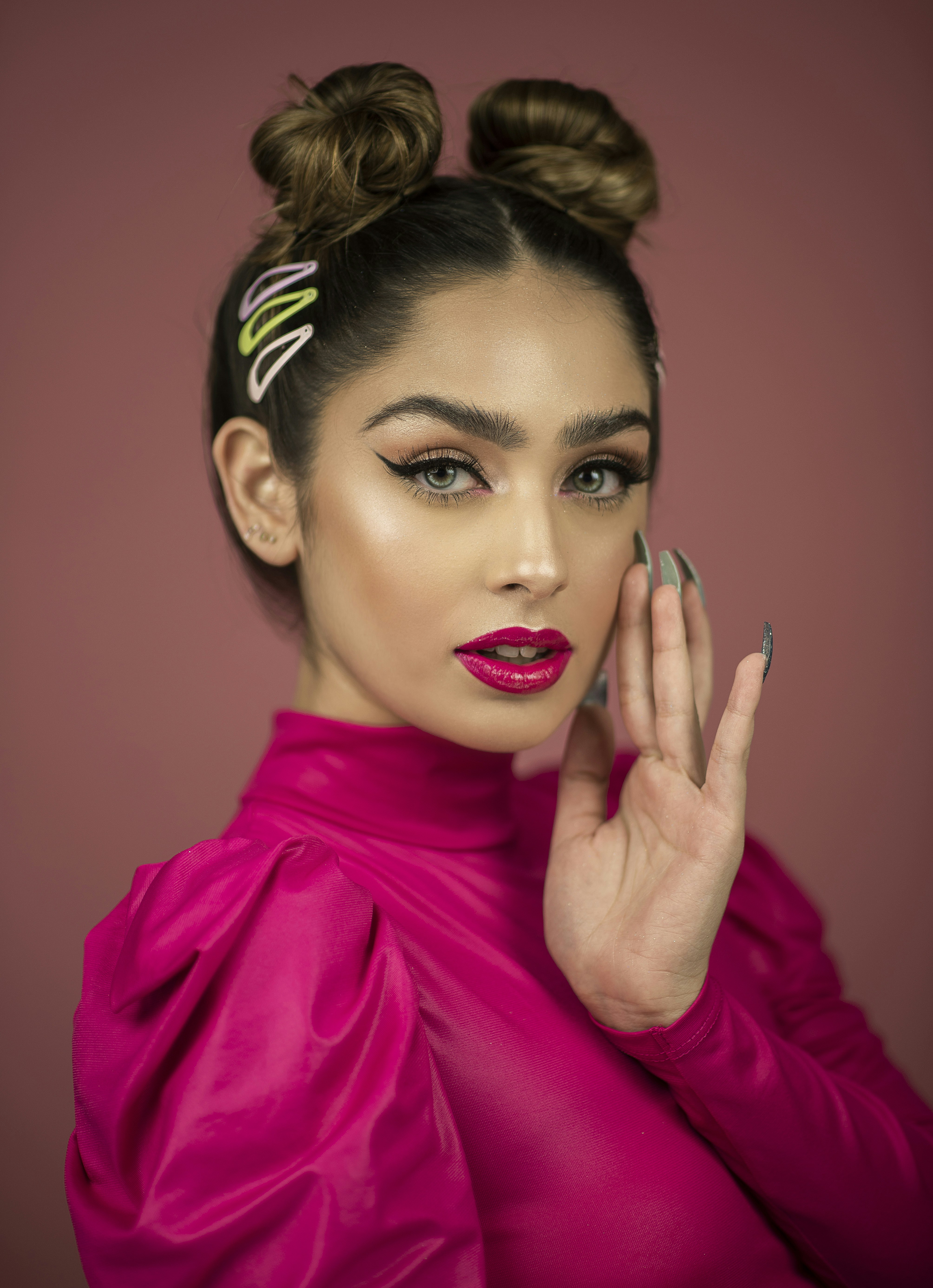 woman in pink turtleneck long-sleeved near wall