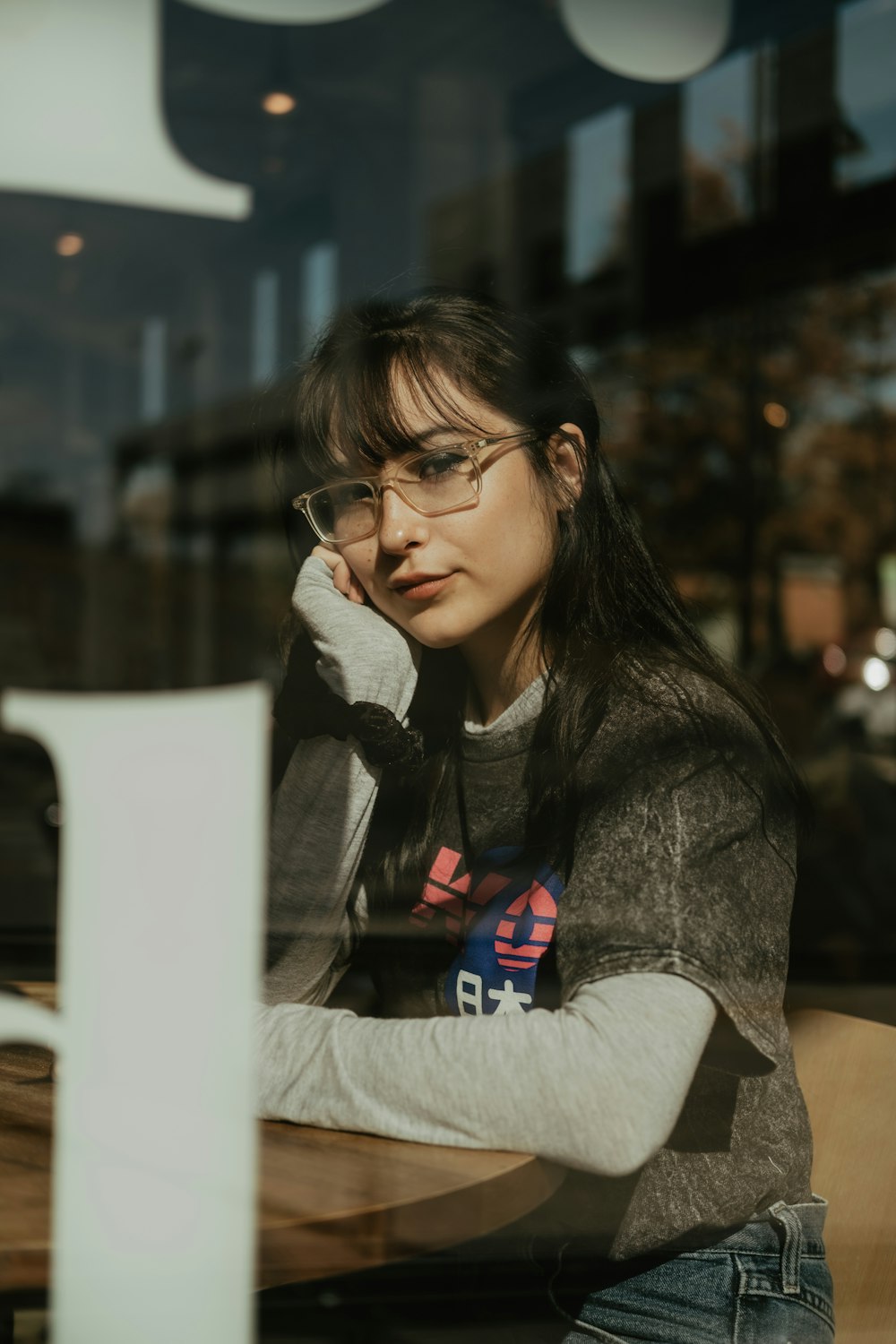 woman leaning on brown table inside the restaurant