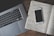 Desk workspace with a laptop and notes focused on real estate marketing strategy.