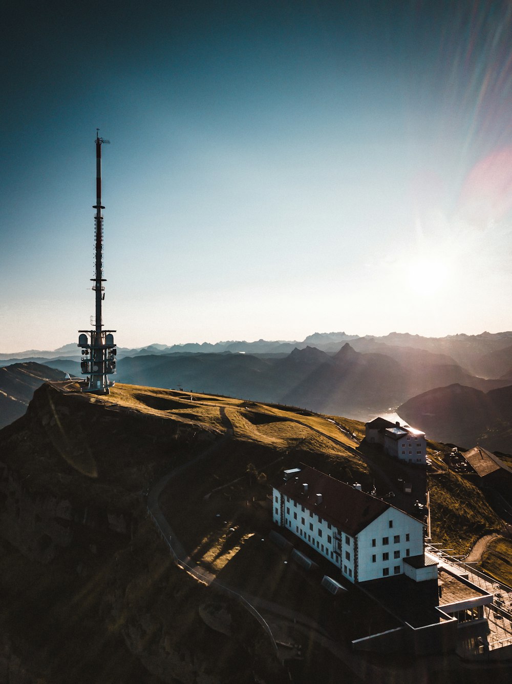 an aerial view of a building on top of a hill