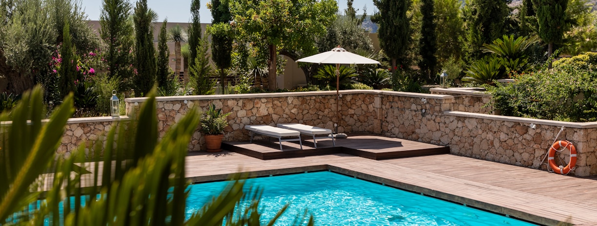 white umbrella by the swimming pool