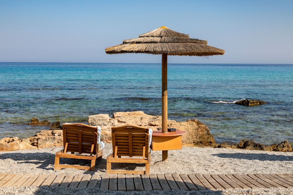 brown lounge chairs beside parasol on island during day