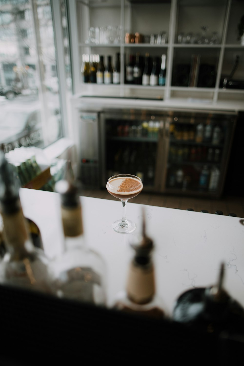 a glass of wine sitting on top of a counter