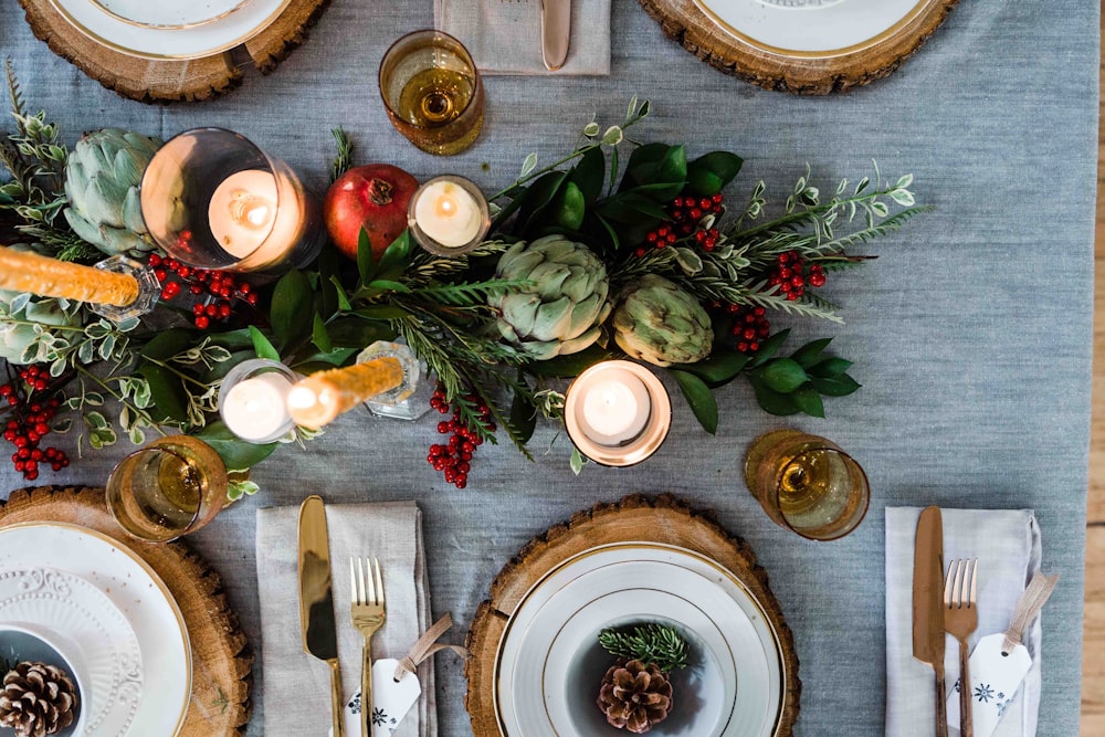 flat lay photography of lit candles with flowers on table