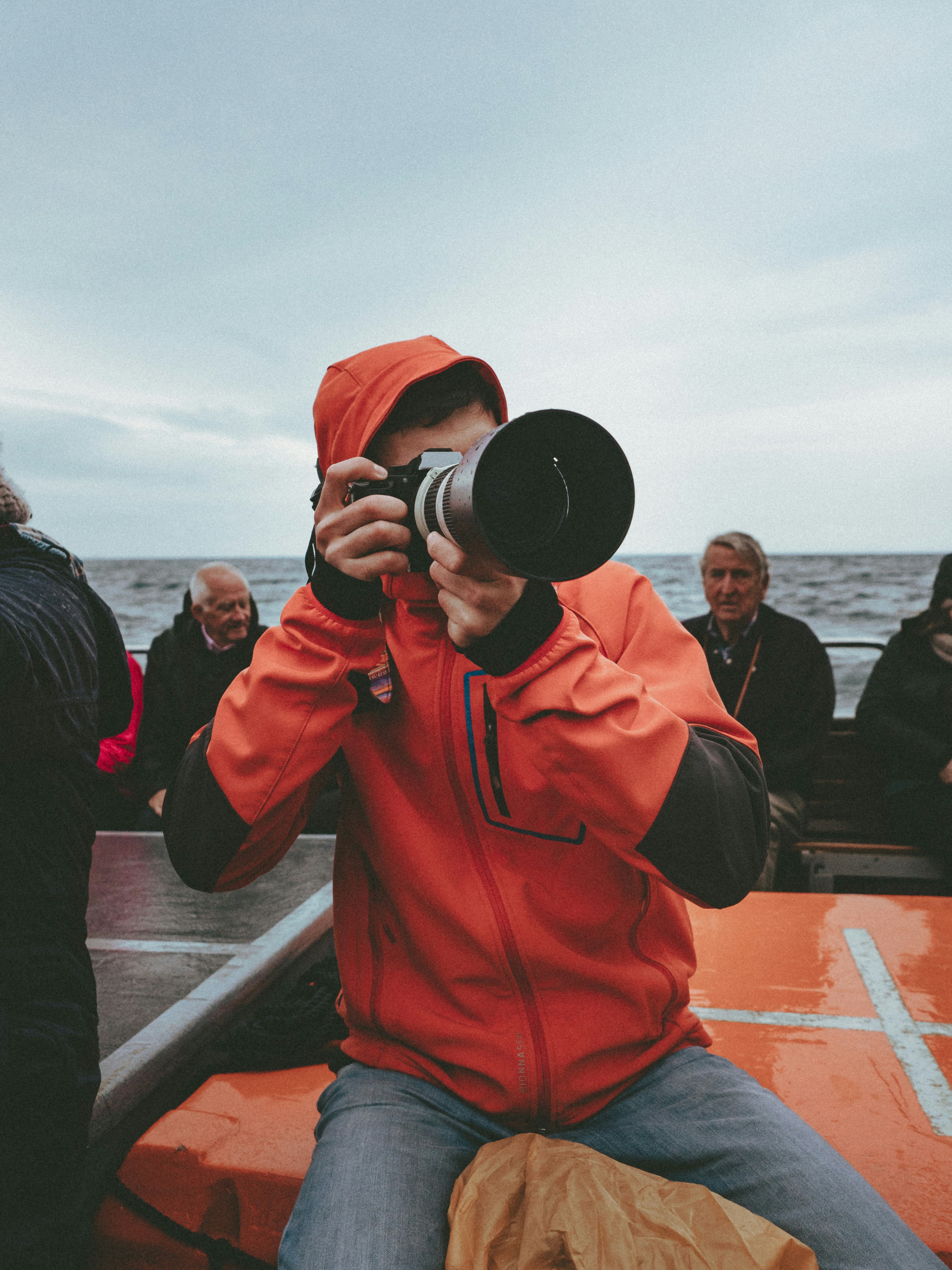 photography of man taking photo using DSLR camera