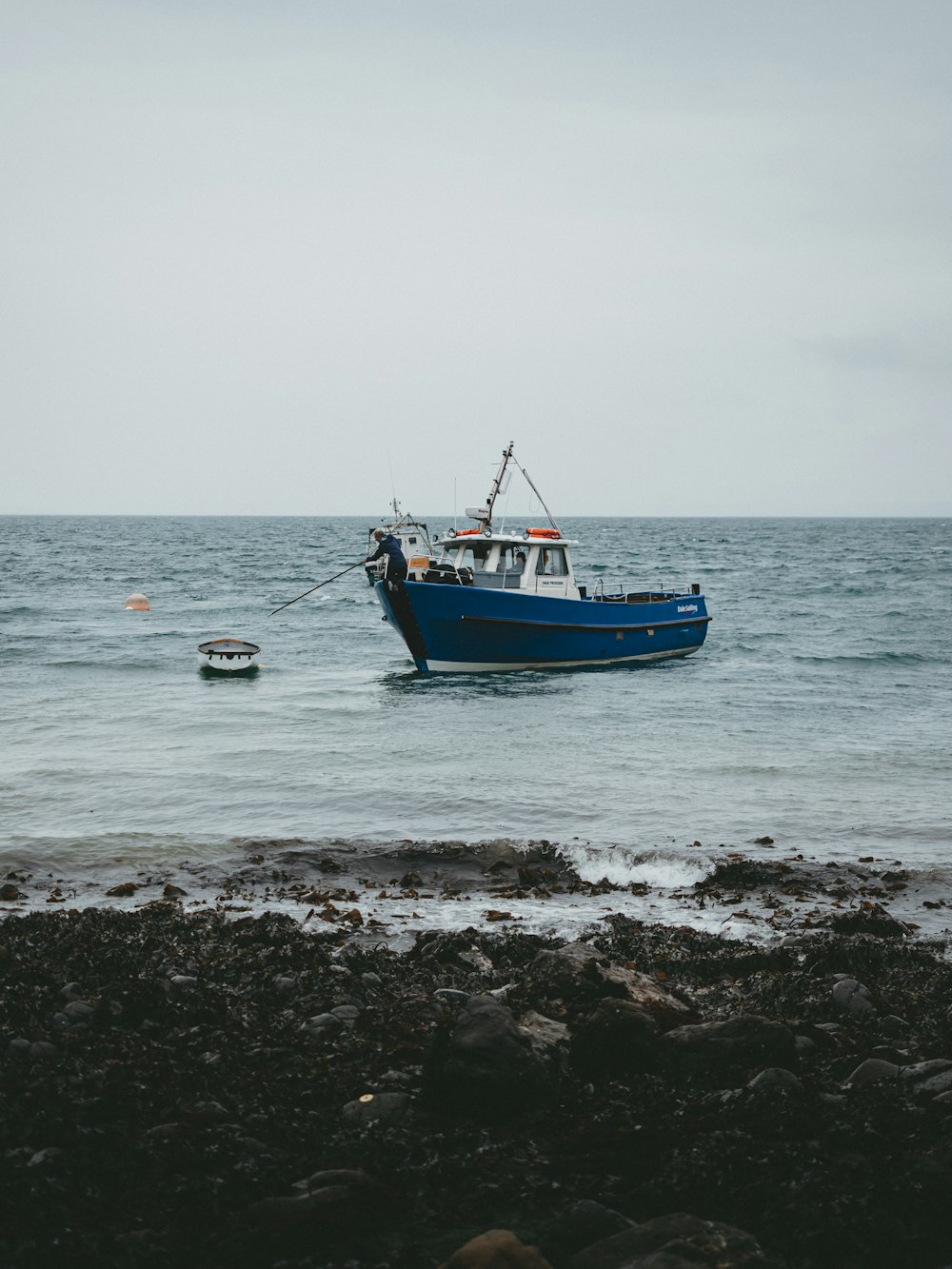 blue canoe boat on seashore