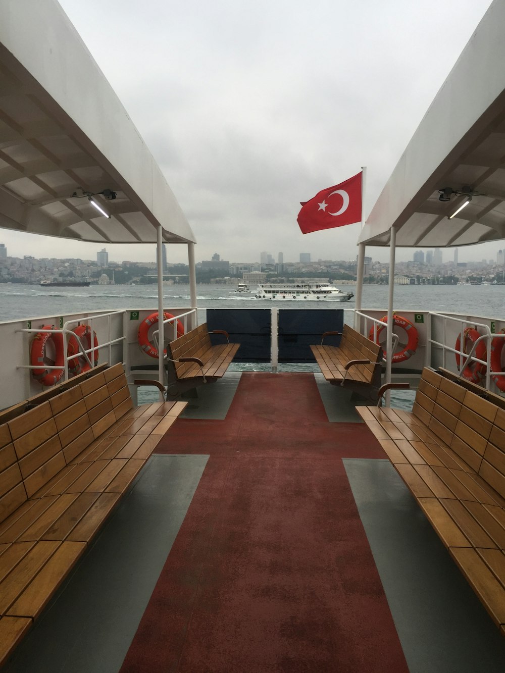 flag of Turkey beside brown wooden bench