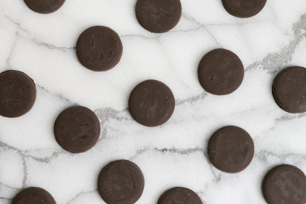 a marble table topped with chocolate covered cookies