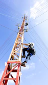 person climbing in electricity tower