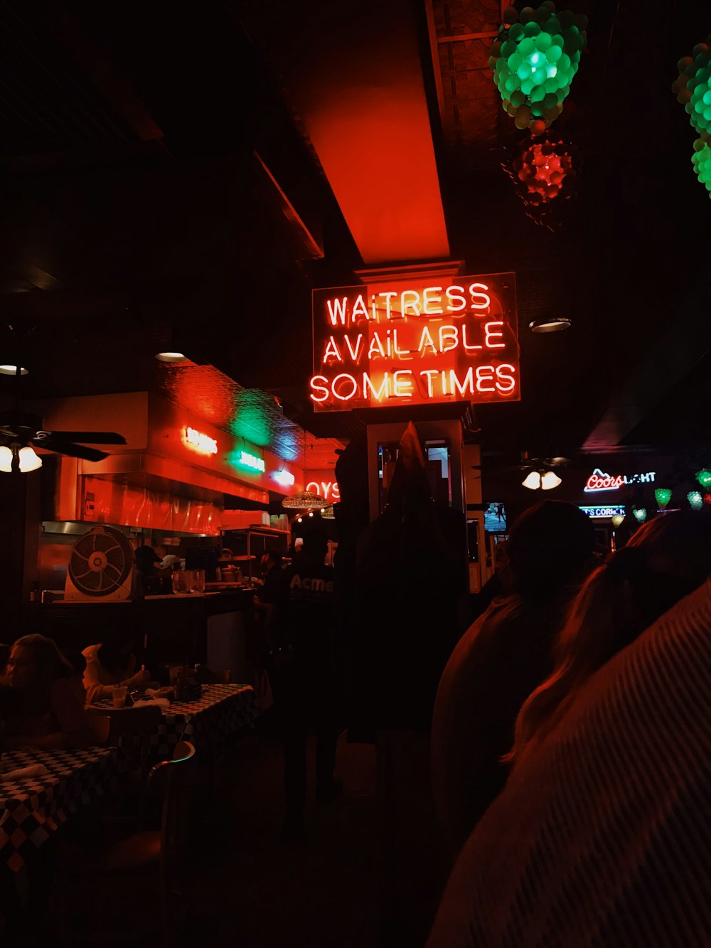 a neon sign that reads waitress available some times