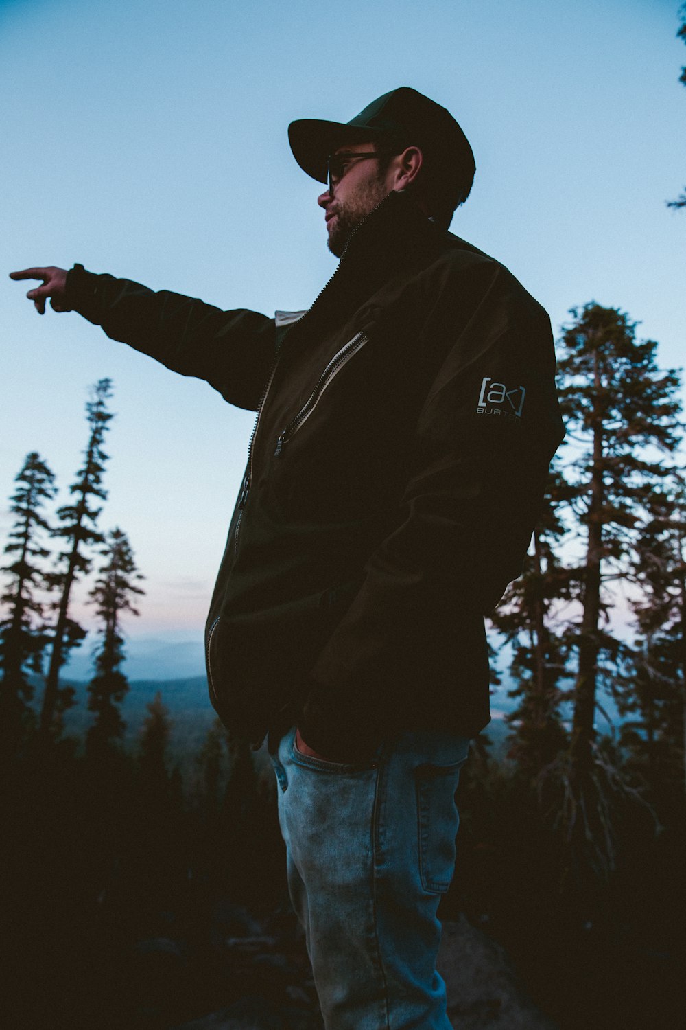 man in black full-zip jacket wearing flat brim cap