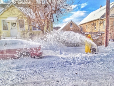 man using snow thrower