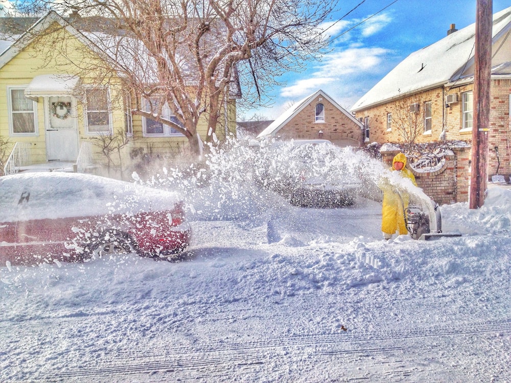 man using snow thrower