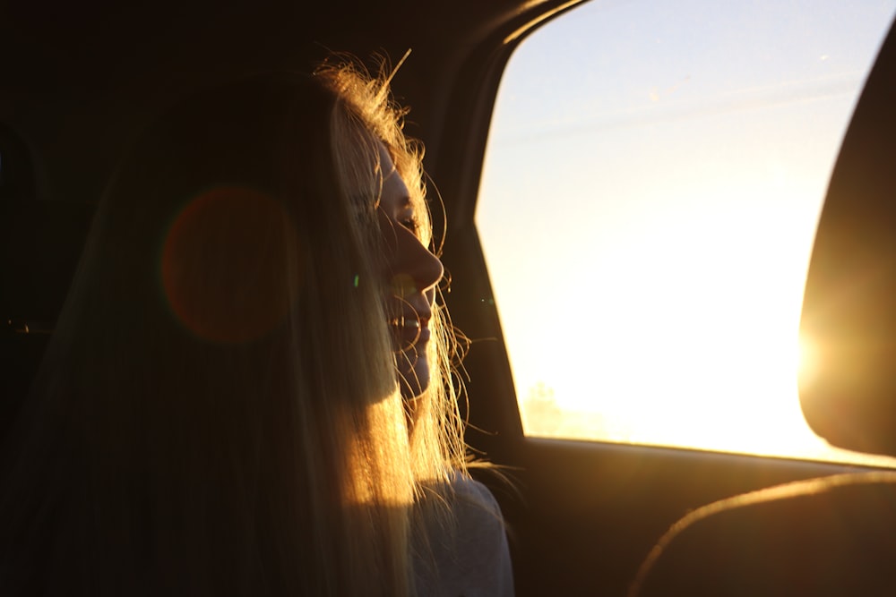 woman sitting on passenger side during golden hour