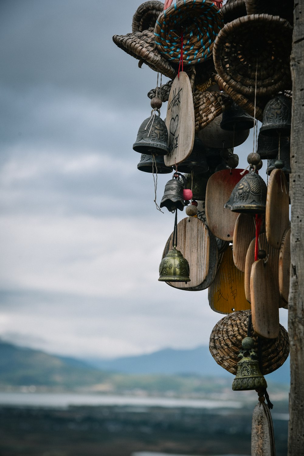 a bunch of bells hanging from the side of a building