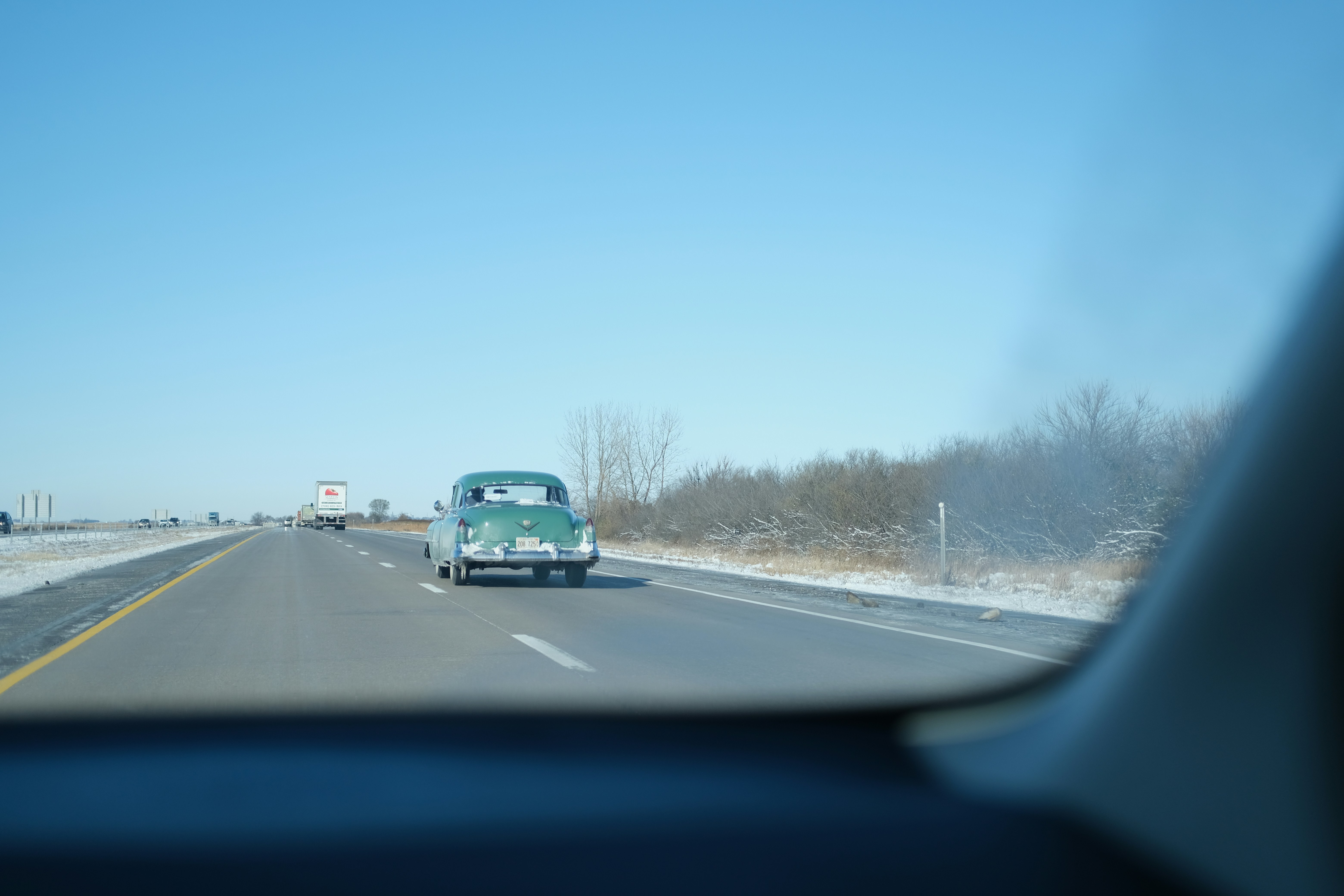 teal vehicle on road