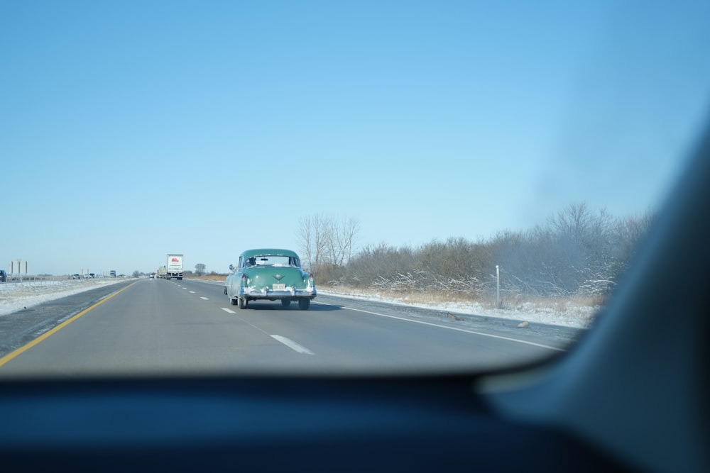 teal vehicle on road