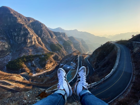 person sitting on cliff in Fangshan China