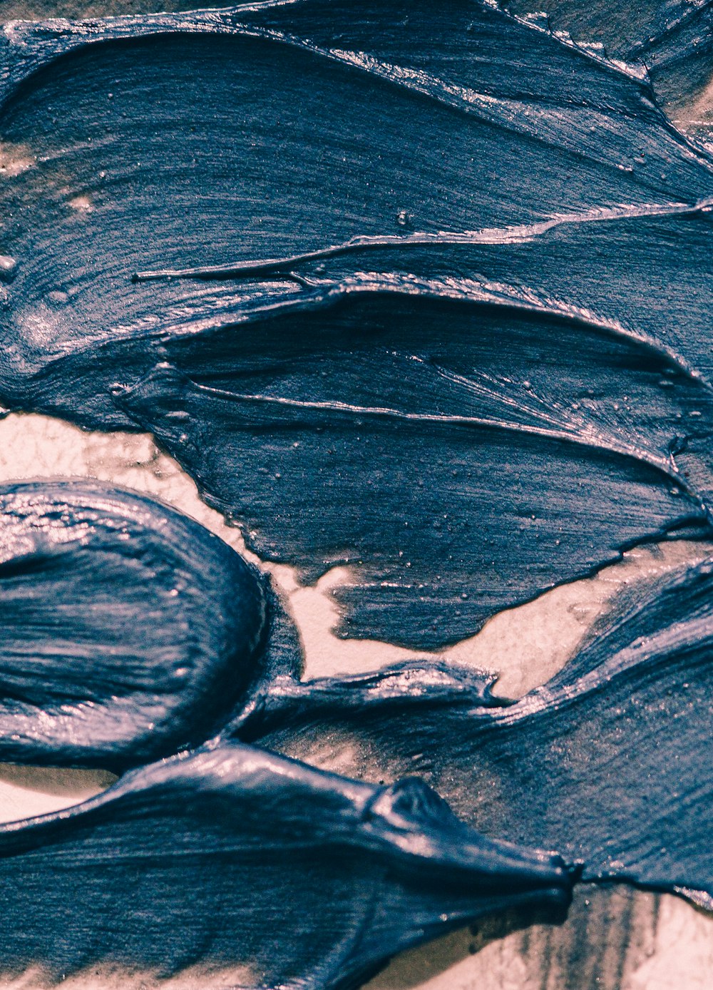 a close up of some blue paint on a table