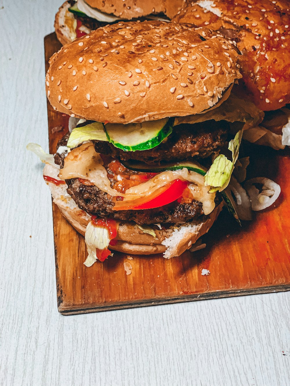 burger dish on brown chopping board