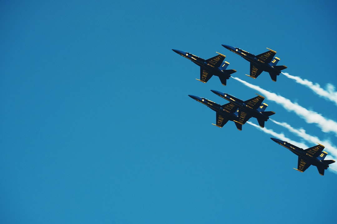 five black jet planes doing exhibition on air during daytime