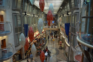 A bustling mall area showcasing a permanent interactive installation with families and shoppers captivated by the experience.