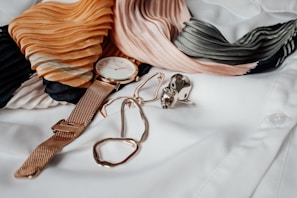 round white and gold-colored analog watch with gold-colored milanese band