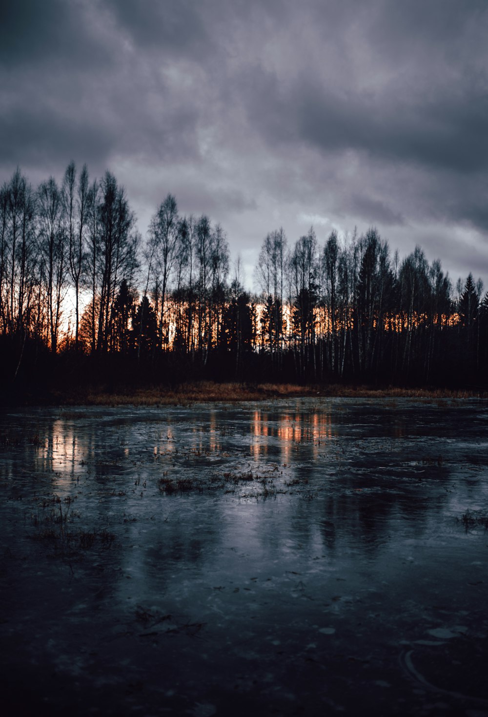 body of water under gray sky