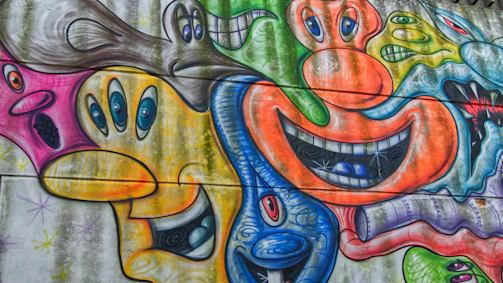 A vibrant mural of colorful abstract faces symbolizing wild, youthful energy.