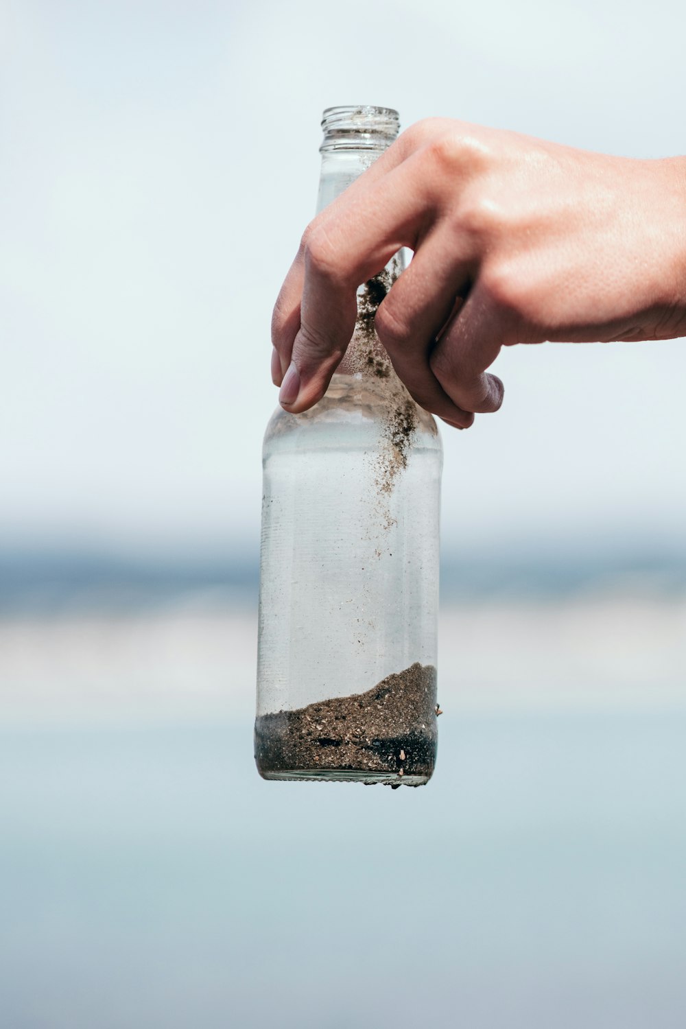 shallow focus photo of clear glass bottle