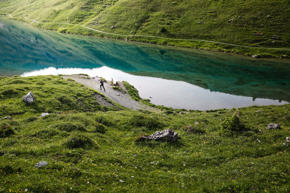 person walking near body of water