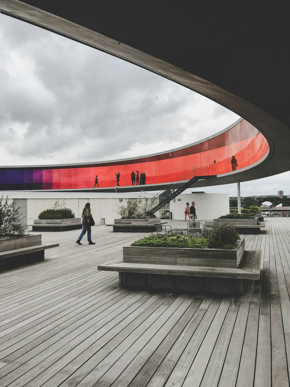 a group of people walking around a wooden deck